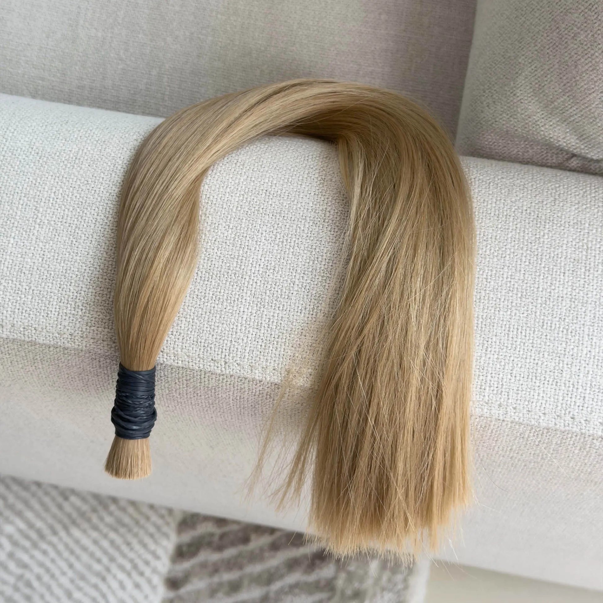 Blonde hair extension on a textured surface
