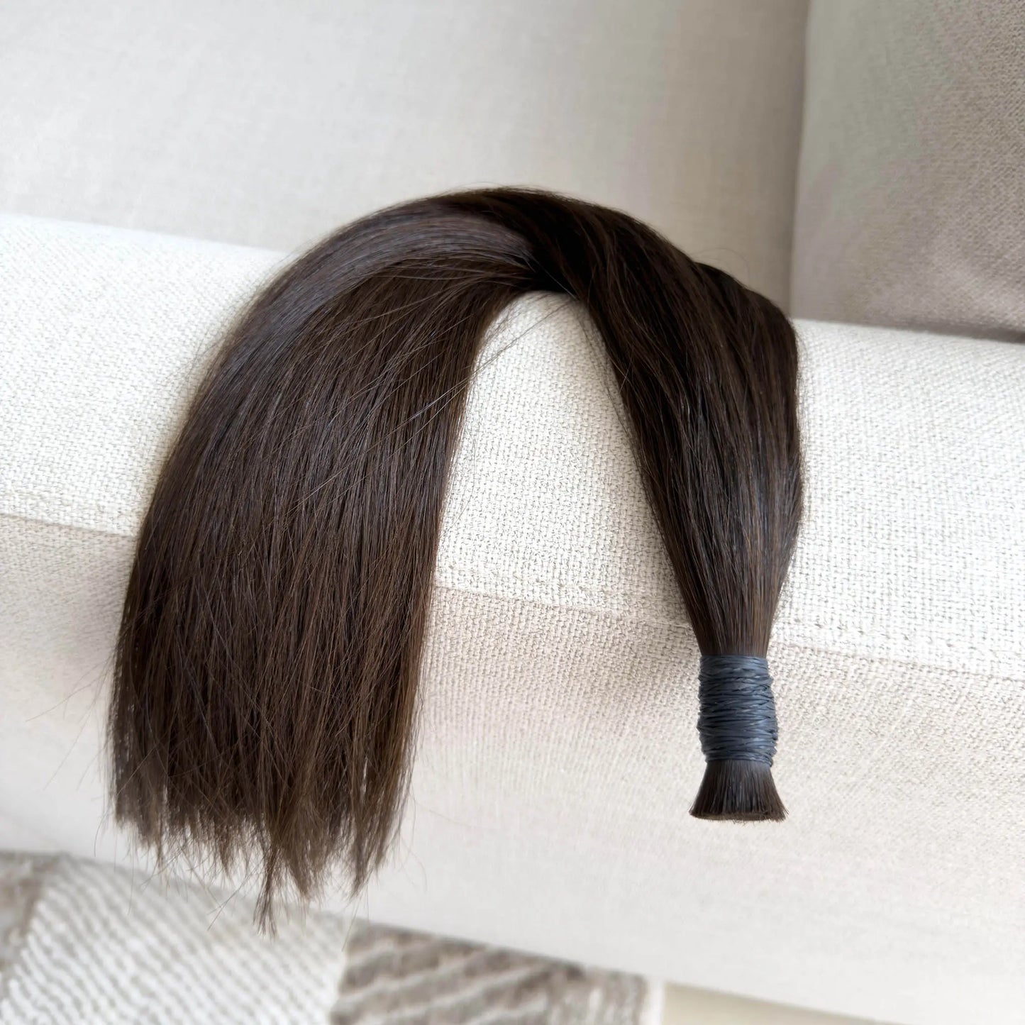 bulk hair extension, colour 4 on the sofa