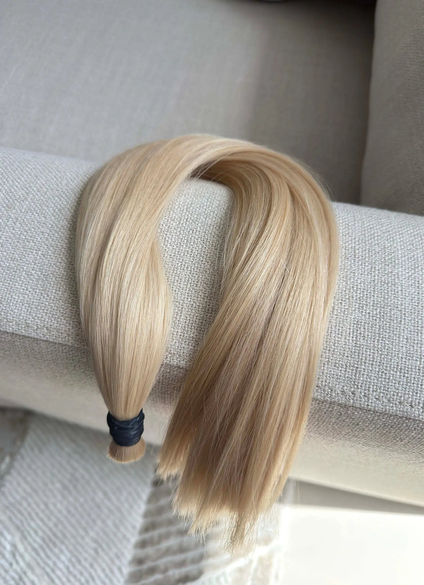 Number 60 hair extensions on a gray surface